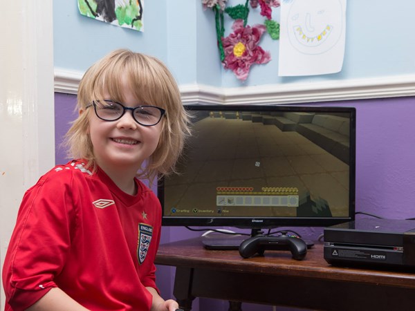 Video Game Child Playing Video Game Smiling at Camera